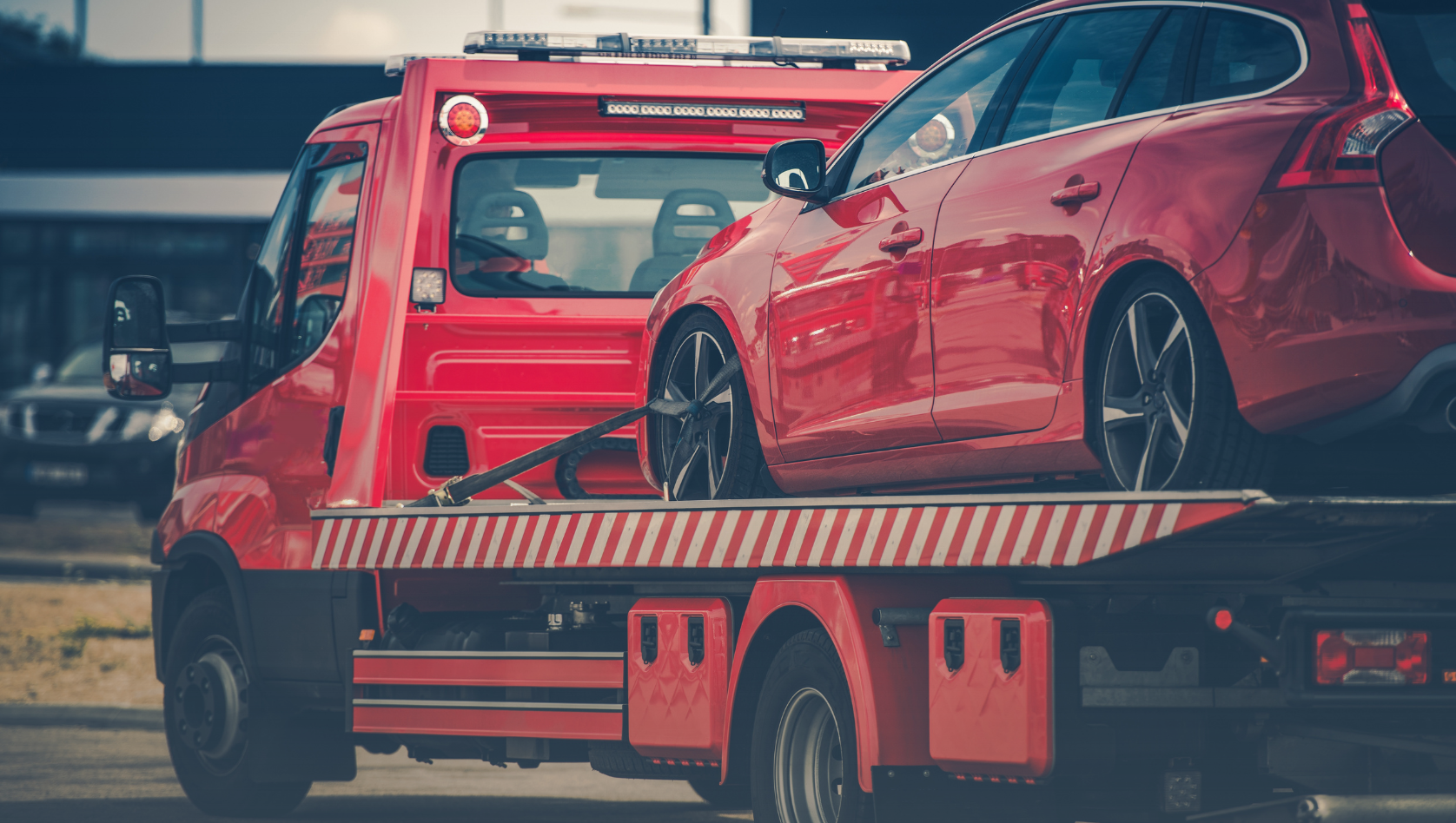 Image shows a car on the back of a recovery truck. Image depicts recovery equipment maintenance tips