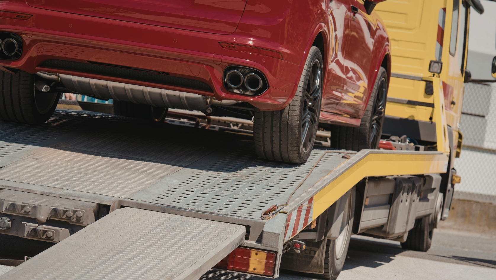Image shows a car on the back of a recovery truck. Image depicts Why Spring Is a Great Time to Replace Worn Recovery Gear