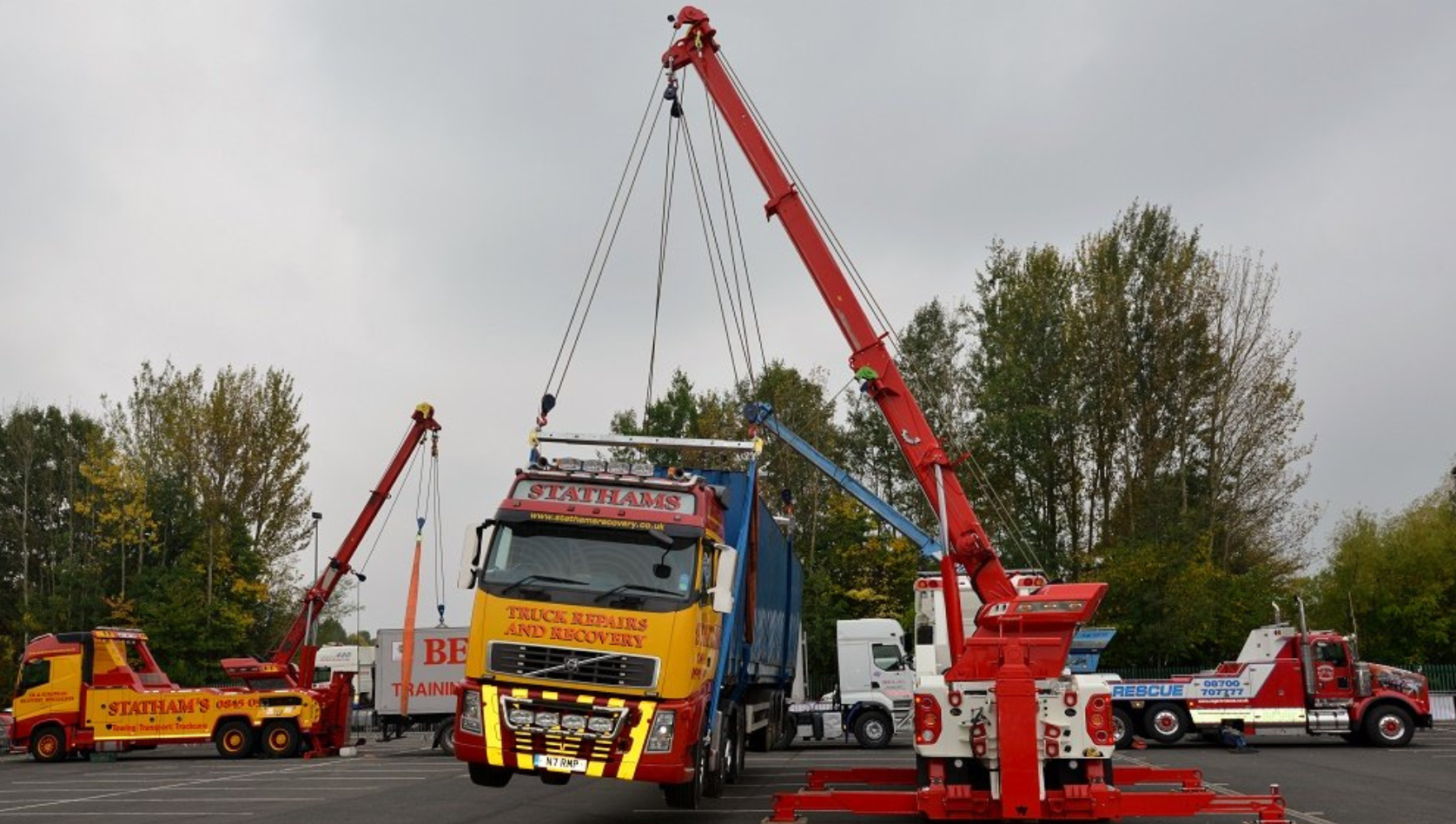 Image shows a lorry being lifted by chain slings